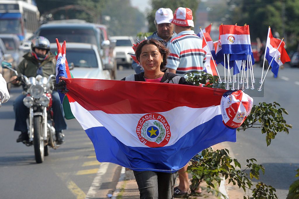 $Guide to Obtaining a Permanent Residency in Paraguay on table